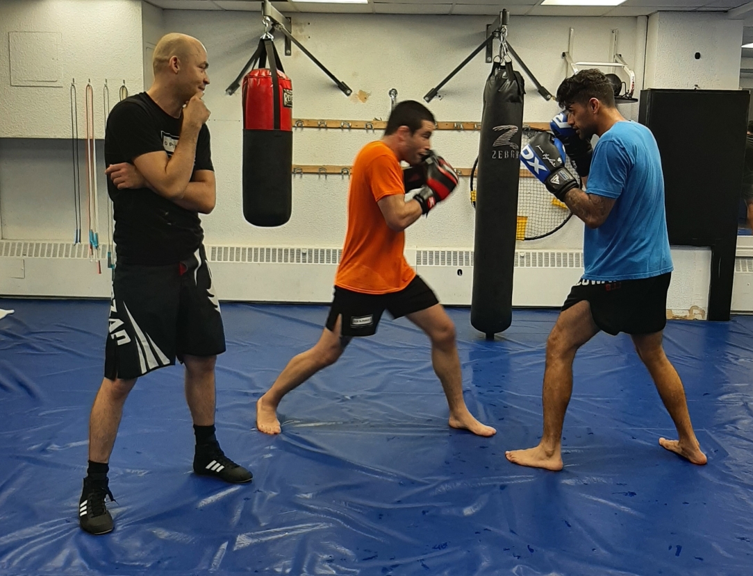 Boxing coach watching students